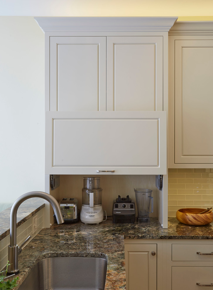 Enclosed kitchen - mid-sized transitional u-shaped medium tone wood floor enclosed kitchen idea in Chicago with a single-bowl sink, raised-panel cabinets, white cabinets, granite countertops, white backsplash, glass tile backsplash, stainless steel appliances and an island