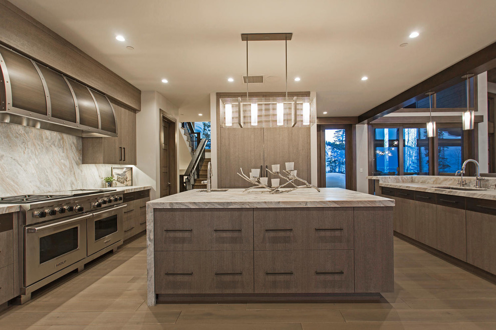Expansive contemporary u-shaped eat-in kitchen in Salt Lake City with a drop-in sink, flat-panel cabinets, medium wood cabinets, marble benchtops, grey splashback, marble splashback, panelled appliances, medium hardwood floors and with island.