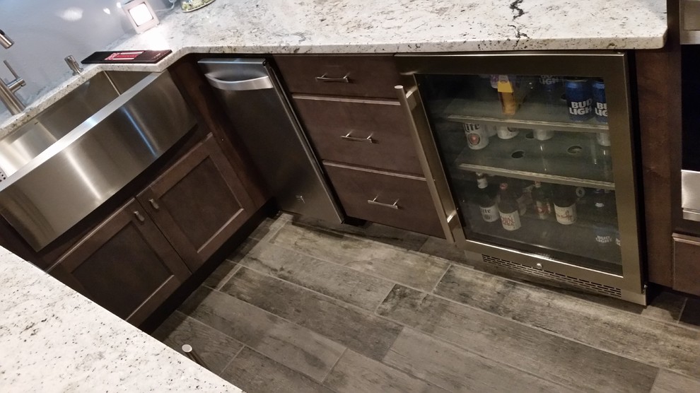Design ideas for a mid-sized traditional u-shaped wet bar in Other with shaker cabinets, dark wood cabinets and granite benchtops.
