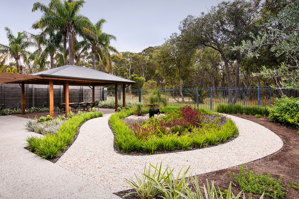 Photo of a large contemporary full sun formal garden in Perth with concrete pavers.