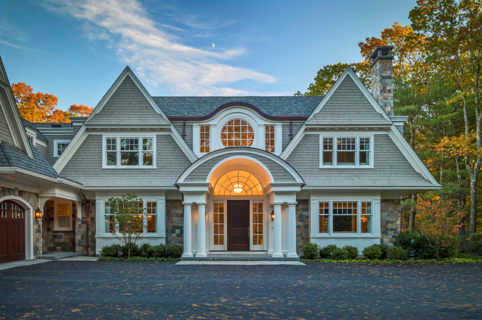 This is an example of a traditional grey house exterior in Boston with wood siding, a gable roof, a shingle roof, a grey roof and shingle siding.