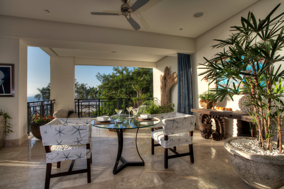 Design ideas for a large contemporary patio in Orange County with tile and a roof extension.