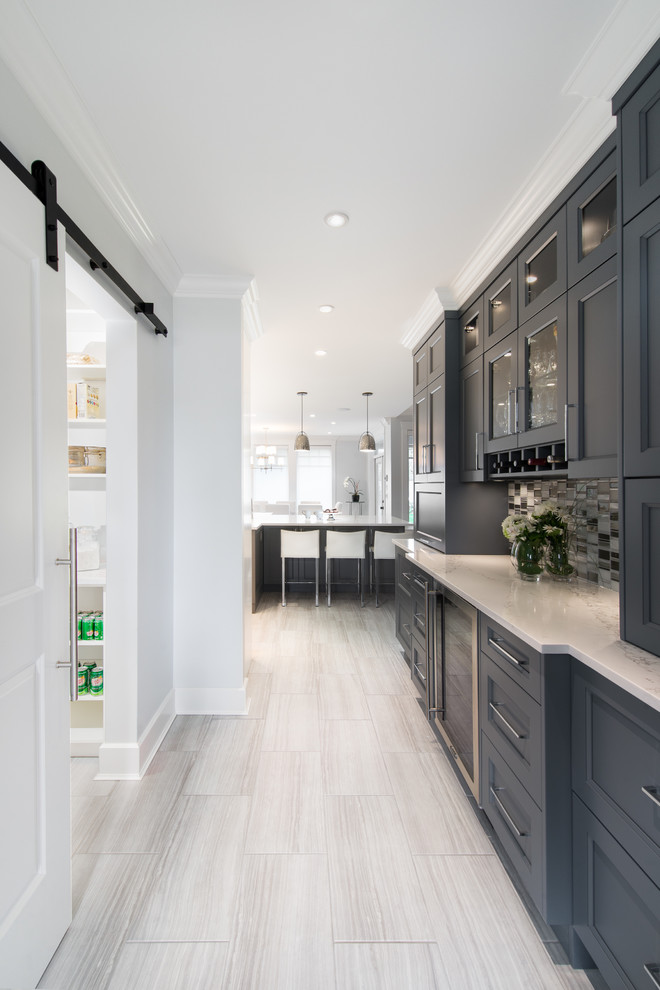 Large contemporary kitchen in Vancouver with a double-bowl sink, shaker cabinets, grey cabinets, quartz benchtops, metallic splashback, metal splashback, stainless steel appliances, porcelain floors and with island.