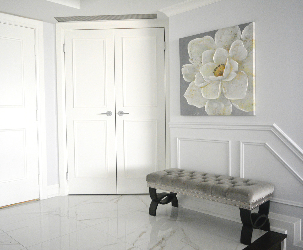 Example of a mid-sized transitional ceramic tile foyer design in Toronto with blue walls and a white front door