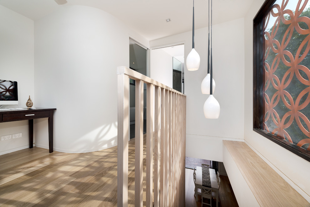 This is an example of a mid-sized contemporary wood straight staircase in Melbourne with open risers.