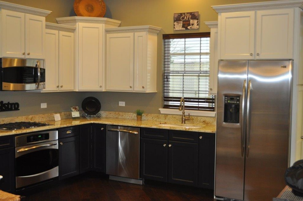 Inspiration for a mid-sized transitional u-shaped brown floor kitchen remodel in Chicago with an undermount sink, shaker cabinets, white cabinets, granite countertops, stainless steel appliances and no island