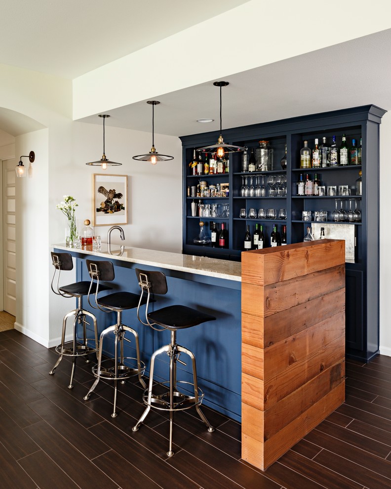 Design ideas for a large transitional galley seated home bar in Portland with open cabinets, blue cabinets, granite benchtops, dark hardwood floors and brown floor.
