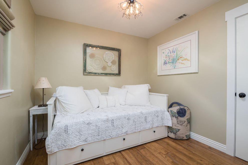 Photo of a small country guest bedroom in Santa Barbara with beige walls, medium hardwood floors and no fireplace.