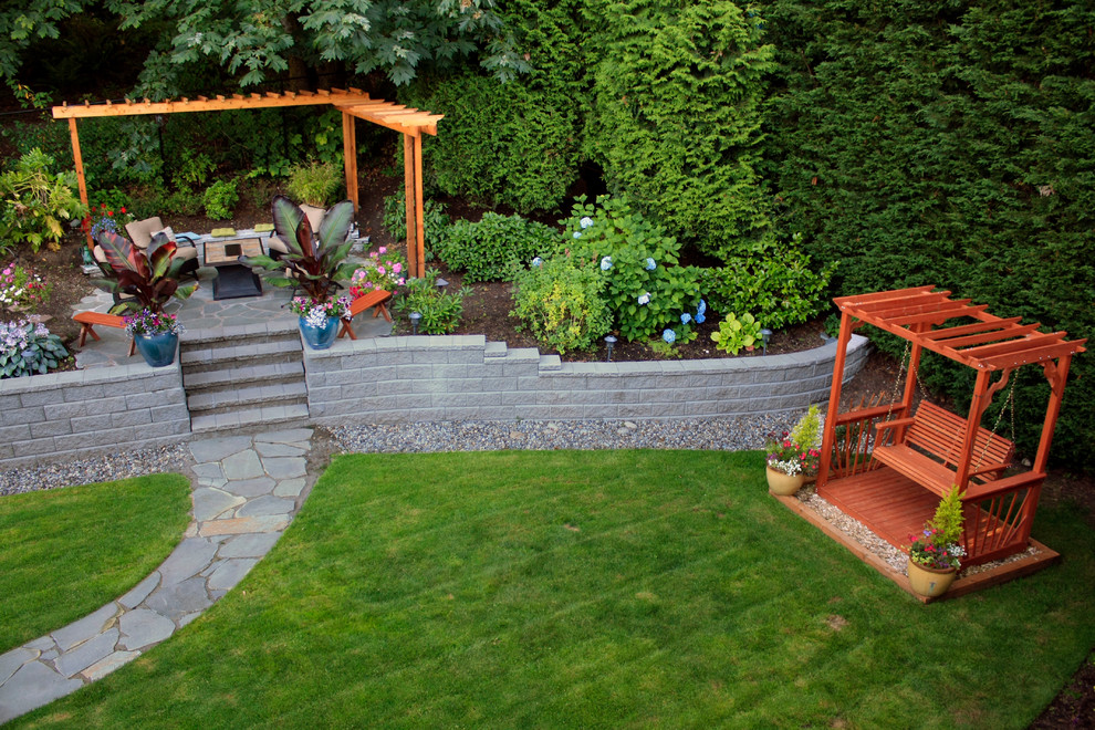 Photo of a traditional backyard garden in Seattle with natural stone pavers.