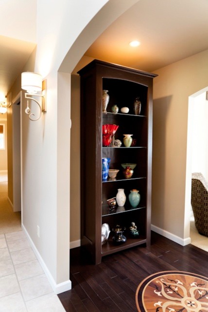 Foyer - small transitional medium tone wood floor foyer idea in Charlotte with beige walls