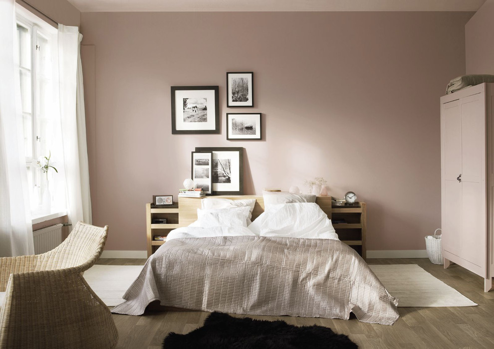 Mid-sized contemporary bedroom with pink walls, no fireplace and medium hardwood floors.