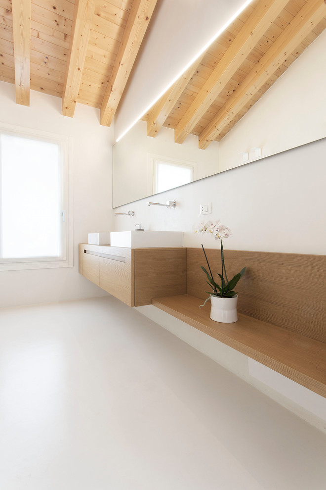 This is an example of a mid-sized contemporary 3/4 bathroom in Venice with light wood cabinets, a curbless shower, beige walls, wood benchtops, a hinged shower door, flat-panel cabinets, white tile, a vessel sink, white floor and brown benchtops.