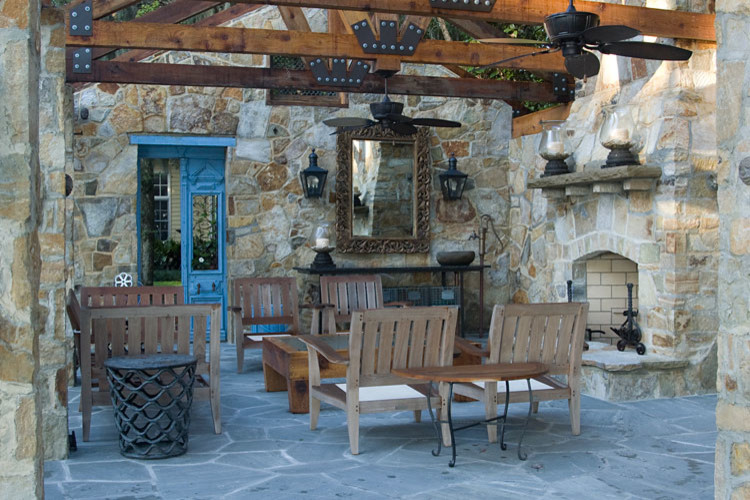 Design ideas for a large country backyard patio in Tampa with with fireplace, natural stone pavers and a gazebo/cabana.