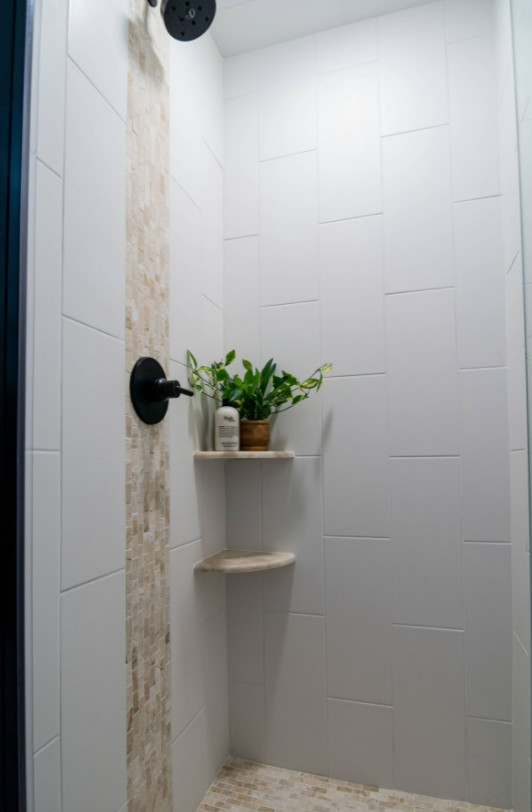 This is an example of a small transitional 3/4 bathroom in Minneapolis with shaker cabinets, brown cabinets, an alcove shower, a wall-mount toilet, white tile, ceramic tile, white walls, laminate floors, an undermount sink, engineered quartz benchtops, beige floor, a hinged shower door, white benchtops, a single vanity and a freestanding vanity.