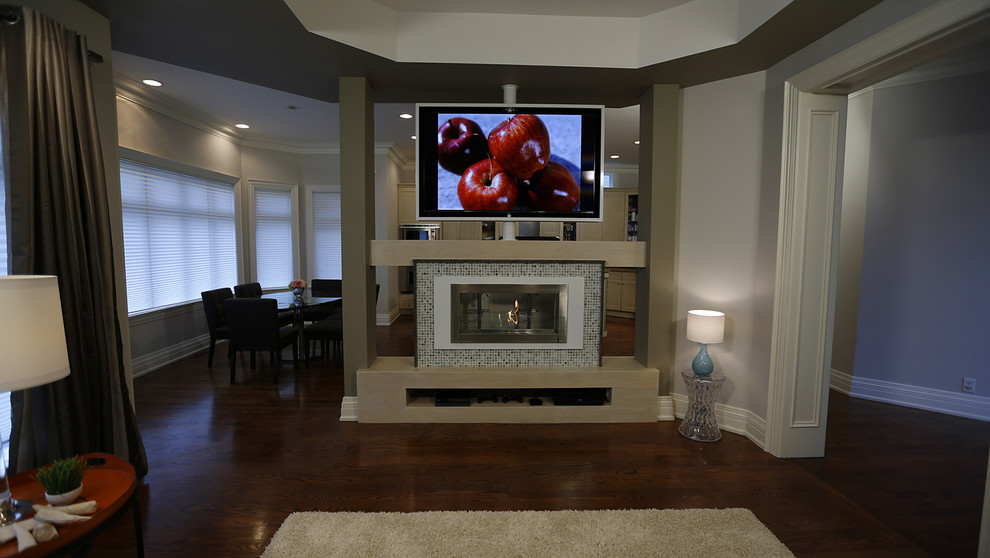 Photo of a mid-sized contemporary open concept living room in Toronto with beige walls, medium hardwood floors, a two-sided fireplace, a tile fireplace surround and a built-in media wall.