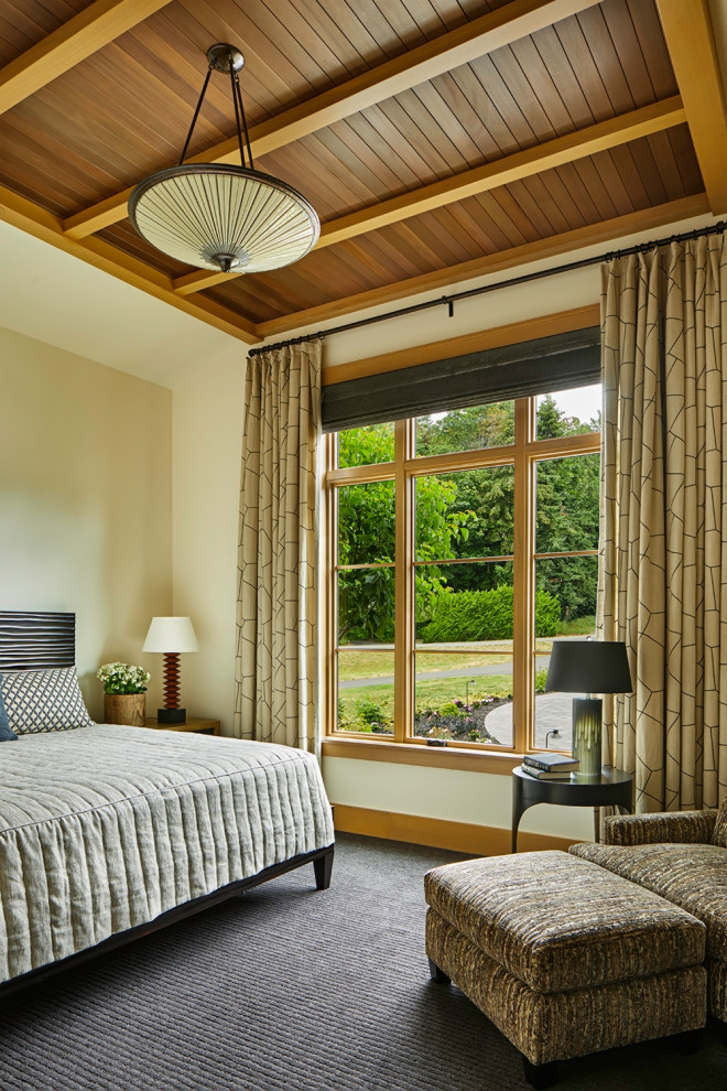 Photo of a transitional master bedroom in Seattle with carpet, grey floor, exposed beam, wood and beige walls.