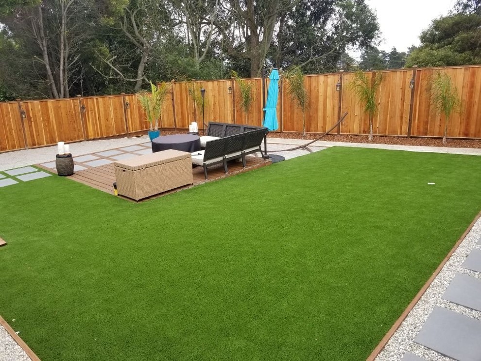 Design ideas for a mid-sized contemporary backyard partial sun formal garden for spring in San Francisco with a garden path and concrete pavers.