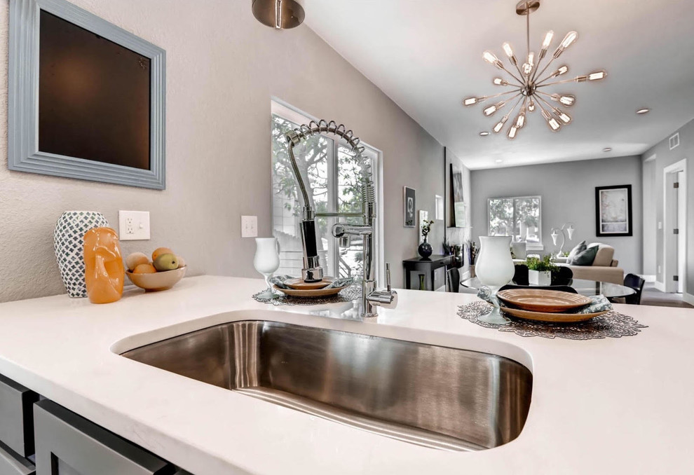 Kitchen - mid-sized transitional kitchen idea with an undermount sink, recessed-panel cabinets, gray cabinets, quartz countertops and a peninsula