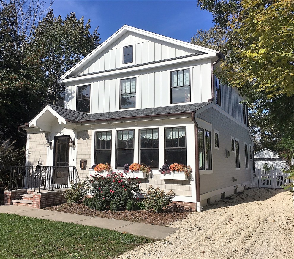 Small beach style two-storey beige exterior in New York with concrete fiberboard siding and a gable roof.
