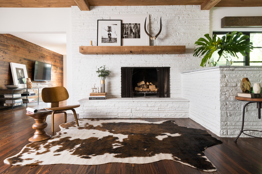 Photo of a contemporary open concept living room in Dallas with white walls, dark hardwood floors, a standard fireplace, a stone fireplace surround and brown floor.