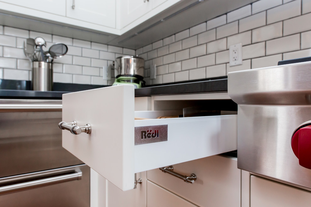 Large transitional u-shaped medium tone wood floor kitchen pantry photo in Calgary with a single-bowl sink, shaker cabinets, white cabinets, quartz countertops, white backsplash, subway tile backsplash, stainless steel appliances and an island
