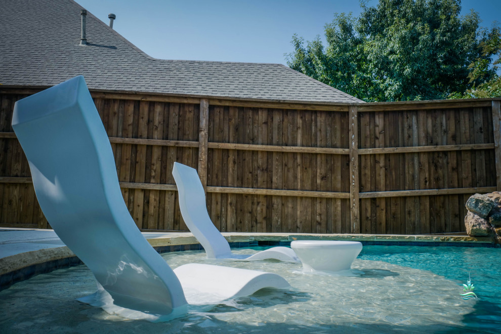 Immagine di una piscina naturale american style personalizzata di medie dimensioni e dietro casa con cemento stampato