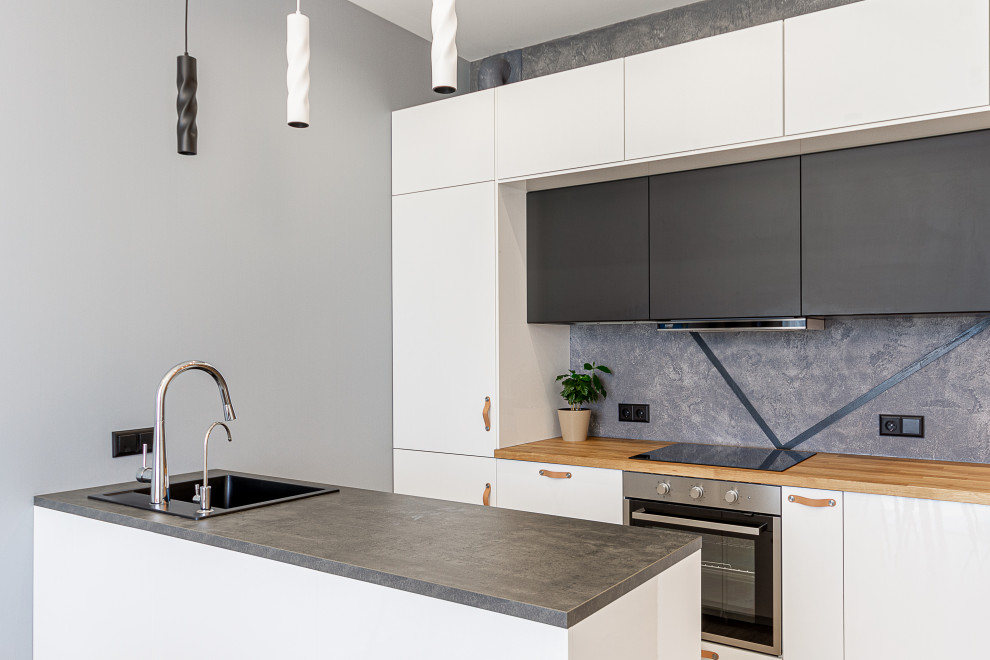 Mid-sized contemporary galley kitchen in Moscow with a drop-in sink, flat-panel cabinets, white cabinets, wood benchtops, grey splashback, stainless steel appliances, a peninsula and beige benchtop.