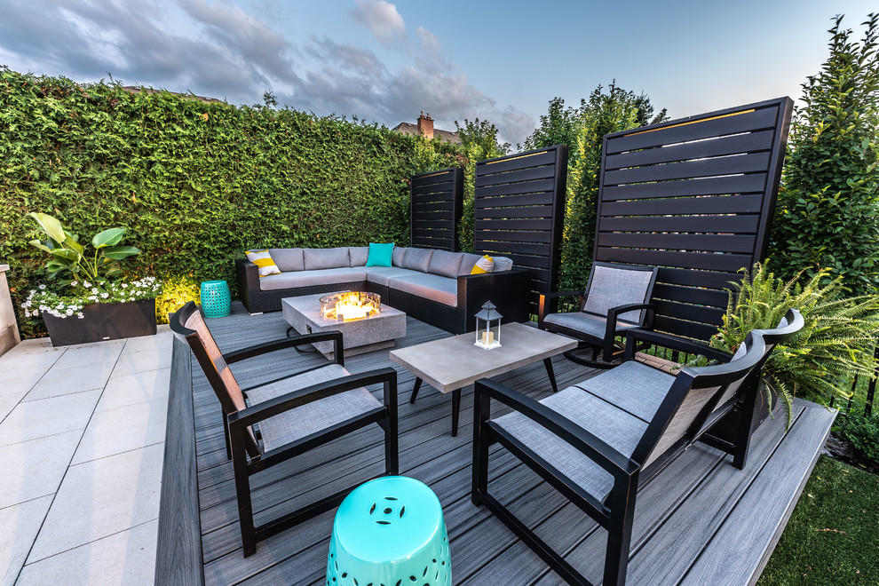 Inspiration for a mid-sized transitional backyard deck remodel in Toronto with a fire pit and no cover