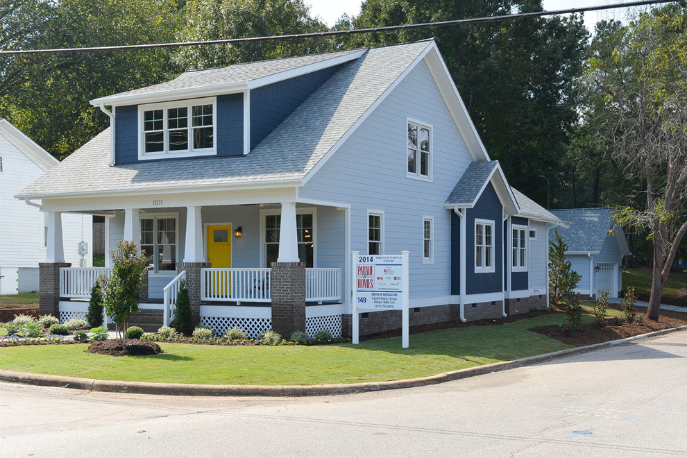 This is an example of a mid-sized arts and crafts two-storey blue exterior in Raleigh with concrete fiberboard siding and a gable roof.