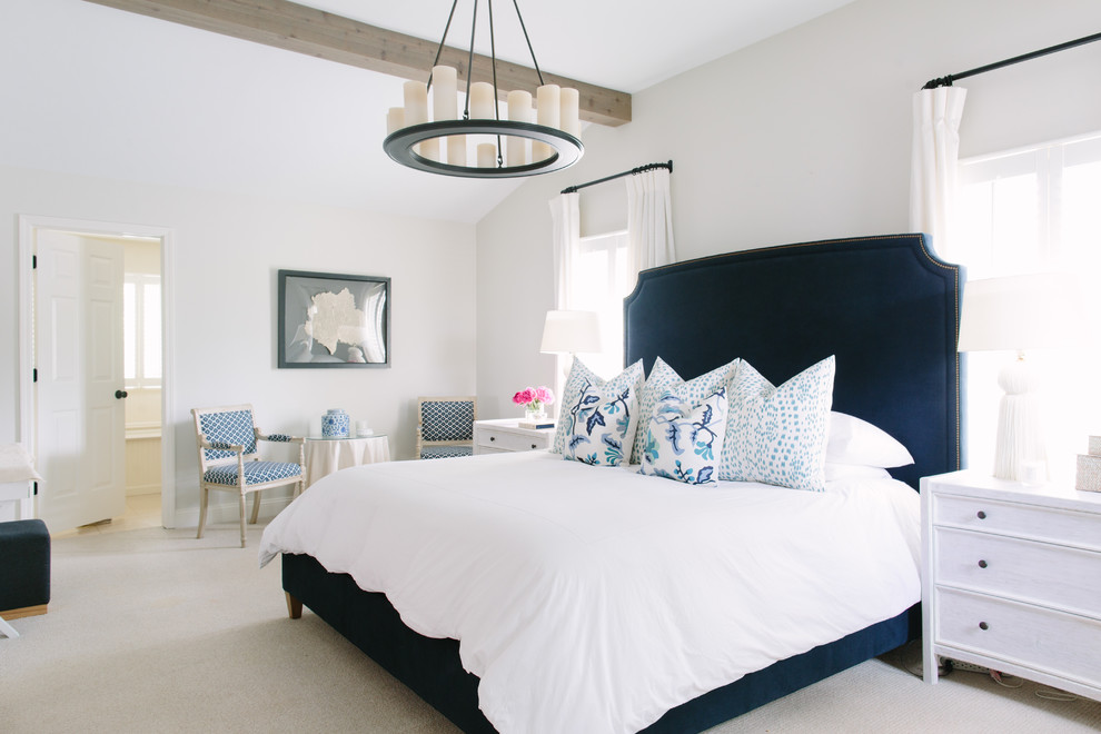 Inspiration for a beach style master bedroom in Chicago with white walls and carpet.