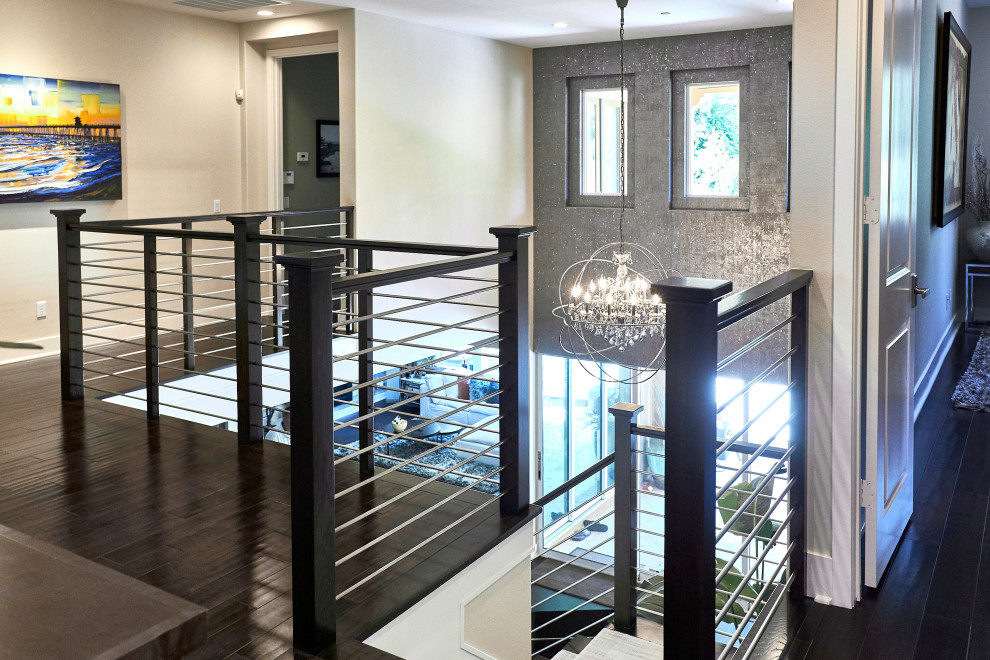 This is an example of a large transitional l-shaped staircase in Orange County with wood railing.