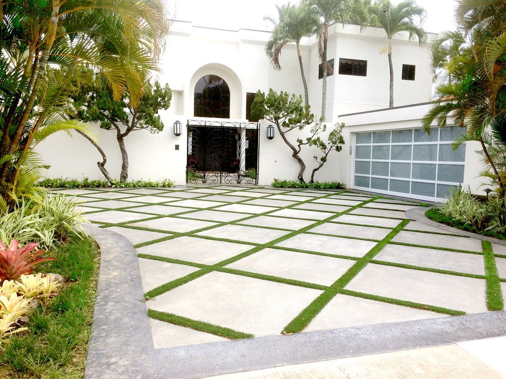 Mid-sized contemporary front yard driveway in Other with concrete pavers.