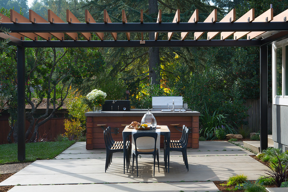 Photo of a mid-sized country backyard patio in San Francisco with an outdoor kitchen, concrete pavers and a pergola.