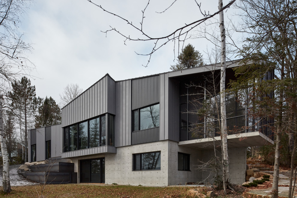 Идея дизайна: большой, двухэтажный, серый частный загородный дом в современном стиле с облицовкой из металла, полувальмовой крышей, металлической крышей, серой крышей и отделкой планкеном