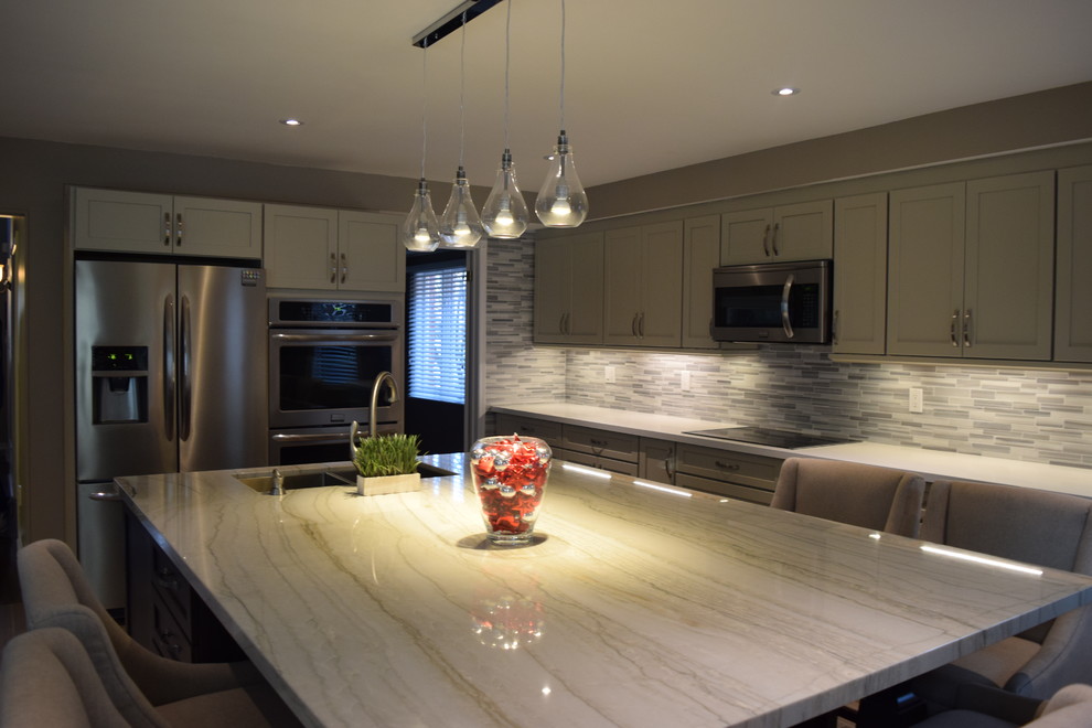 Mid-sized transitional l-shaped eat-in kitchen photo in Toronto with an undermount sink, shaker cabinets, gray cabinets, quartzite countertops, multicolored backsplash, subway tile backsplash, stainless steel appliances and an island