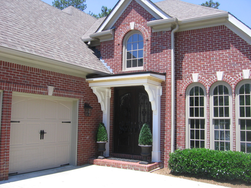 Small elegant front porch photo in Atlanta with a roof extension