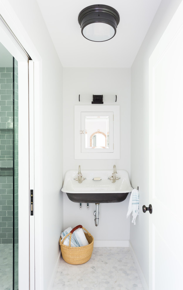 This is an example of a small beach style 3/4 bathroom in Los Angeles with an alcove shower, subway tile, a wall-mount sink, a two-piece toilet, blue tile, grey walls, marble floors and grey floor.