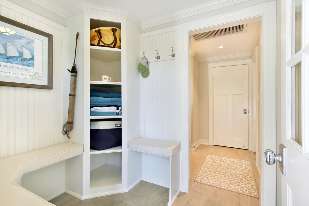 Small beach style mudroom in New York with grey walls, ceramic floors, a single front door and a white front door.