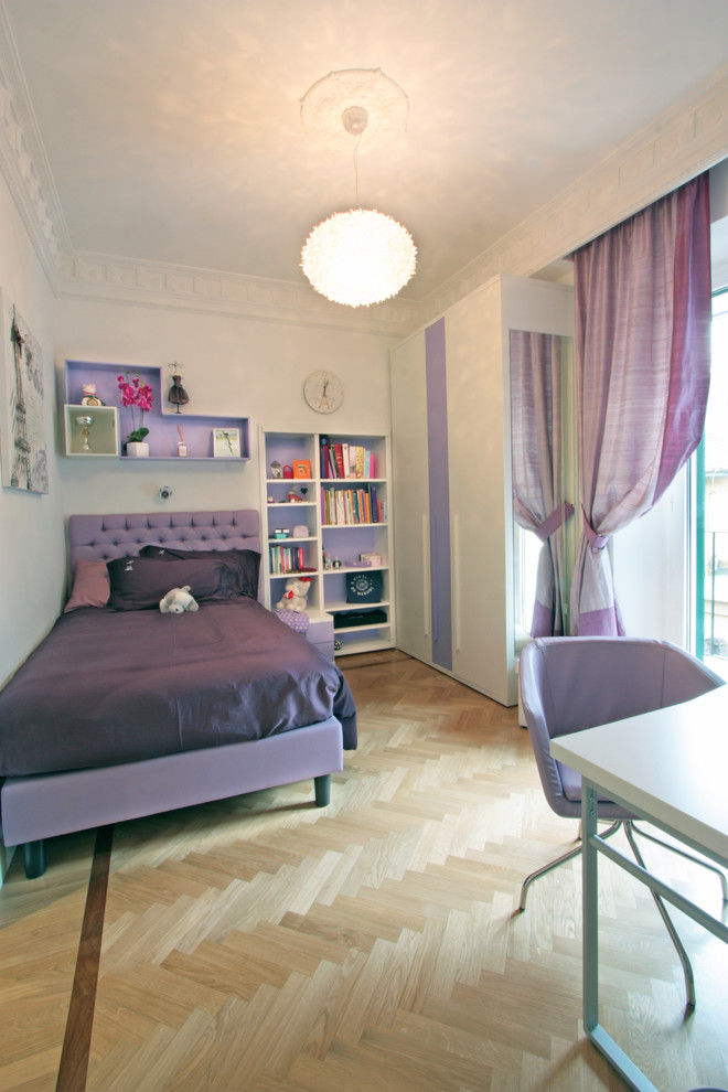 Photo of a large traditional kids' room for girls in Rome with white walls and light hardwood floors.