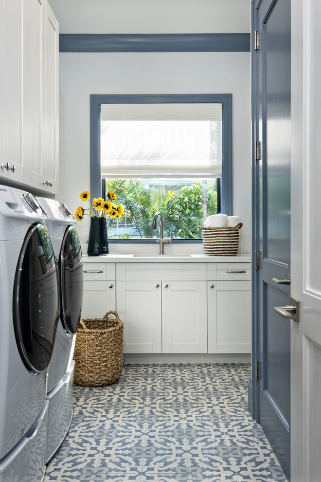 Inspiration for a transitional dedicated laundry room in Miami with shaker cabinets, quartzite benchtops, porcelain floors, a side-by-side washer and dryer and blue floor.