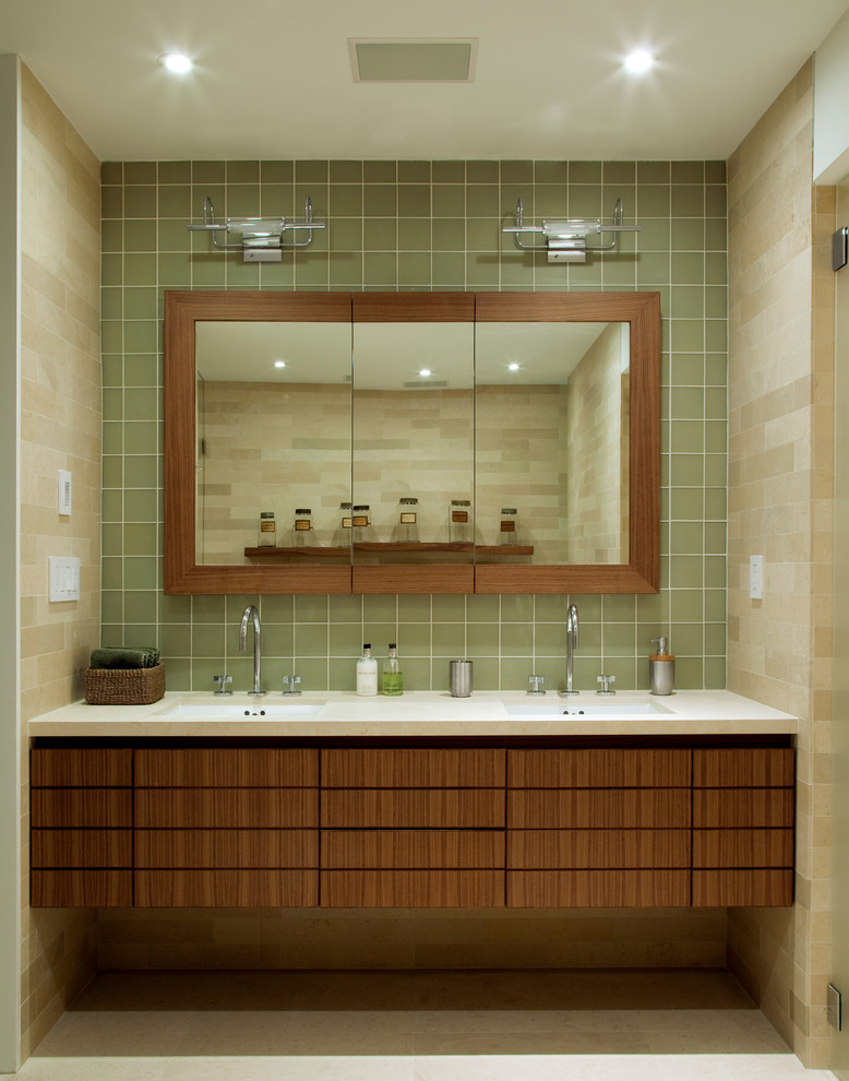 This is an example of a modern bathroom in New York with an undermount sink, medium wood cabinets, flat-panel cabinets and green tile.