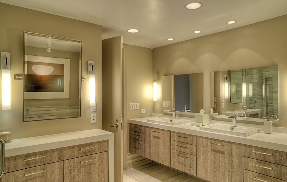 Design ideas for a mid-sized contemporary master bathroom in Chicago with a drop-in tub, flat-panel cabinets, light wood cabinets, a corner shower, a two-piece toilet, gray tile, porcelain tile, beige walls, porcelain floors, engineered quartz benchtops, grey floor, a hinged shower door and a drop-in sink.