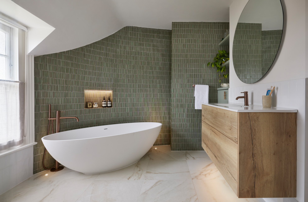 This is an example of a medium sized contemporary ensuite bathroom in Sussex with a freestanding bath, a single sink and a floating vanity unit.