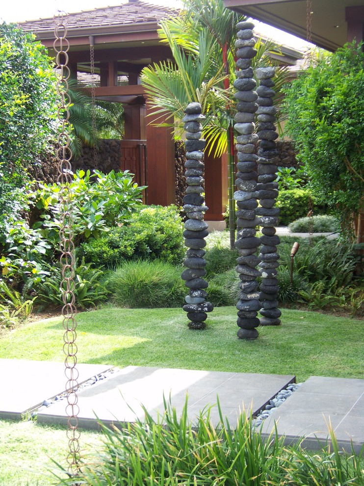 Design ideas for a mid-sized tropical front yard partial sun garden in Hawaii with concrete pavers.