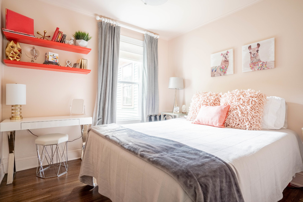 Small transitional guest bedroom in New York with pink walls, light hardwood floors and brown floor.