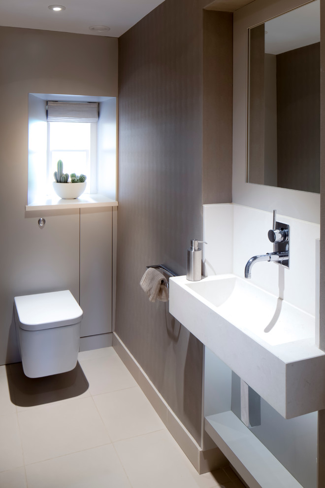 Photo of a contemporary powder room in Gloucestershire with a vessel sink and a wall-mount toilet.