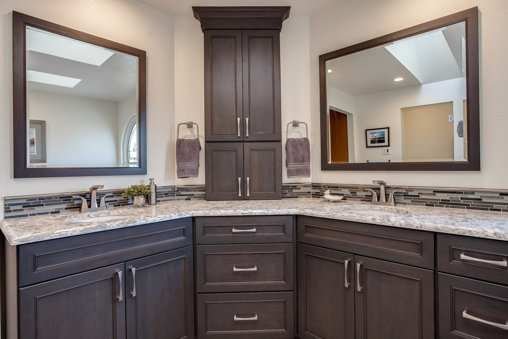 This is an example of a large contemporary master bathroom in Denver with shaker cabinets, brown cabinets, a japanese tub, a curbless shower, gray tile, white walls, medium hardwood floors, an integrated sink, granite benchtops, brown floor, a hinged shower door, white benchtops, a shower seat, a double vanity and a built-in vanity.