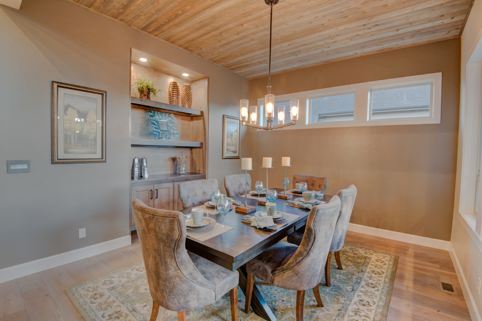 This is an example of a mid-sized transitional separate dining room in Boise with beige walls, light hardwood floors, no fireplace and beige floor.