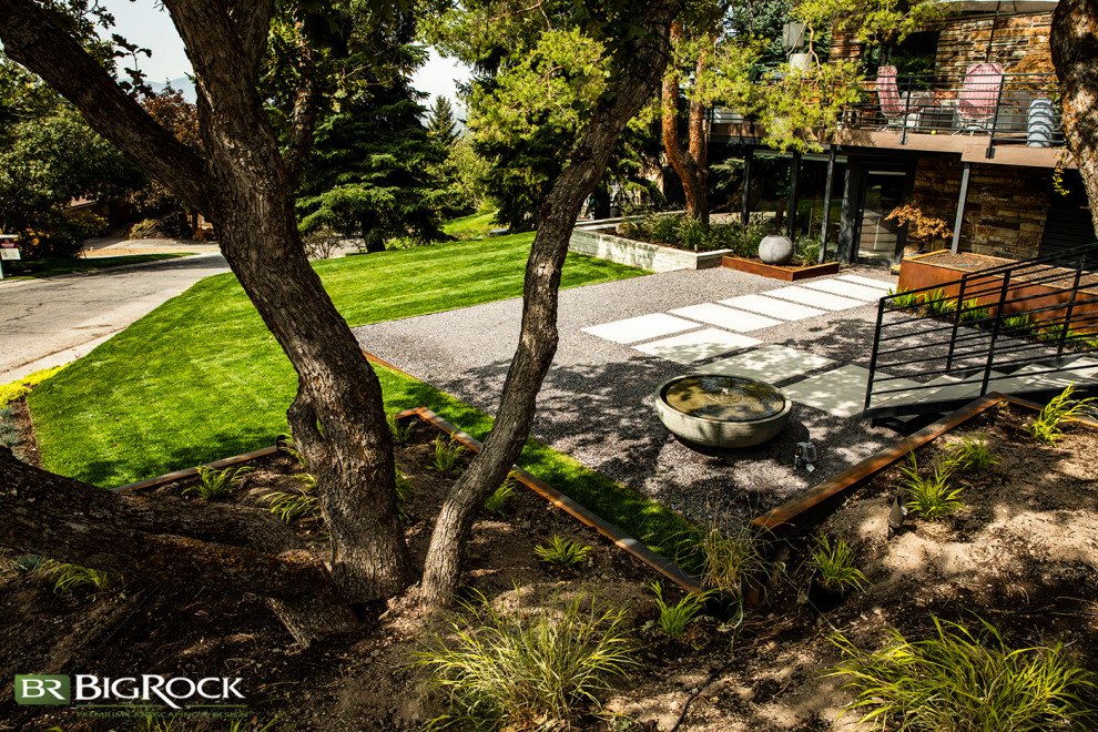 Inspiration for a large contemporary front xeriscape garden in Salt Lake City with a waterfall and concrete paving.