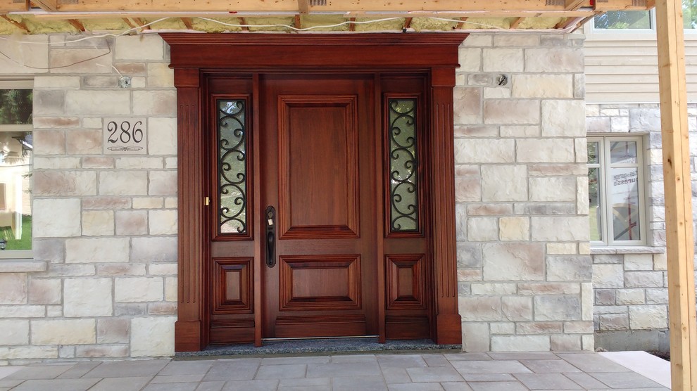Front door - traditional front door idea in Montreal with a dark wood front door